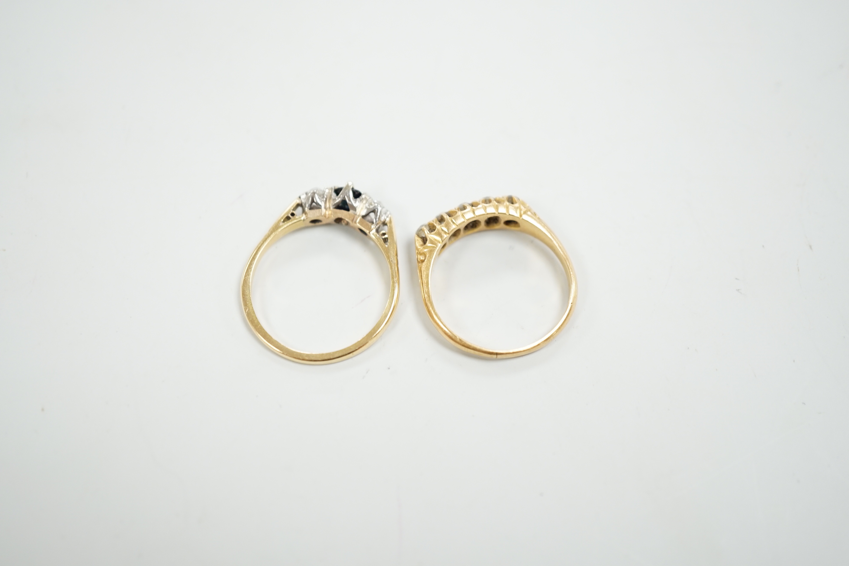 A George V 18ct gold and graduated five stone diamond chip set half hoop ring, size O and a similar 18ct, sapphire and diamond set three stone ring, gross weight 6 grams.